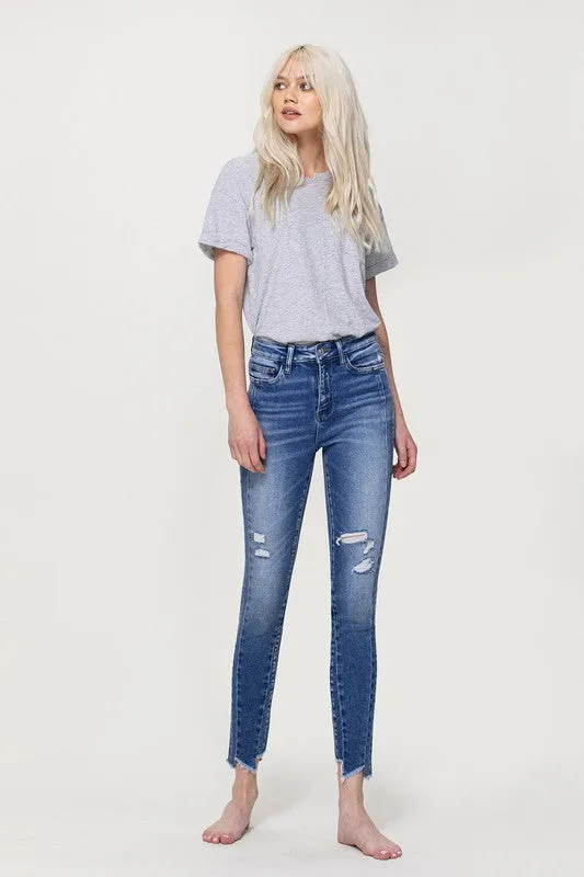 HIGH RISE ANKLE SKINNY W UNEVEN HEM DETAIL