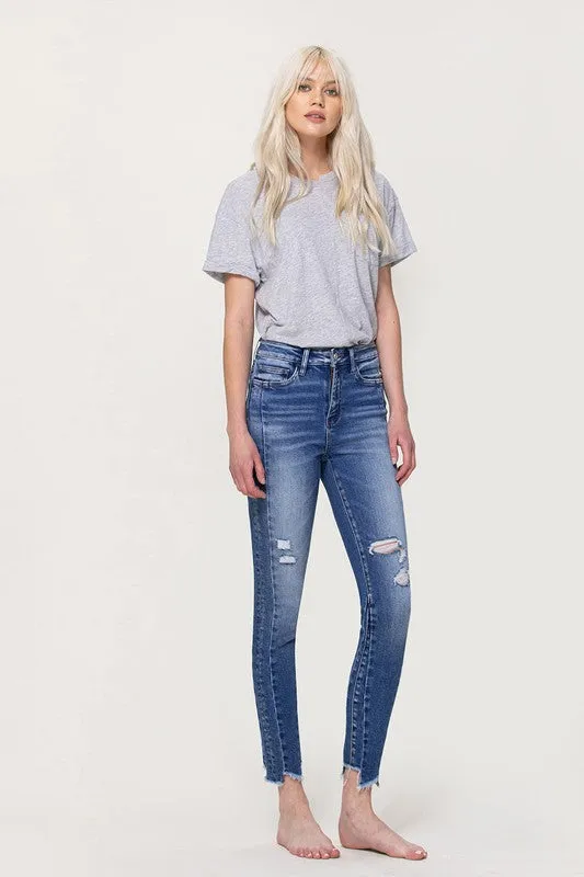 HIGH RISE ANKLE SKINNY W UNEVEN HEM DETAIL